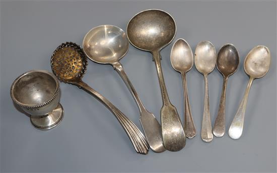 A George IV silver sifter spoon, a William IV silver sauce ladle, a silver egg cup and five plated spoons.